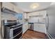 Modern kitchen with stainless steel appliances and white shaker cabinets at 3744 Miller Ct, Wheat Ridge, CO 80033