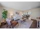 Bright living room features a comfy sofa, stylish coffee table, and large windows at 3744 Miller Ct, Wheat Ridge, CO 80033