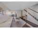 Open living area with hardwood floors, sofa, and view to dining area at 3744 Miller Ct, Wheat Ridge, CO 80033