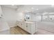 Basement wet bar with white cabinets and quartz countertop at 8916 Snake River St, Littleton, CO 80125