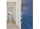 Bright entryway with a navy blue door and hardwood floors at 8916 Snake River St, Littleton, CO 80125