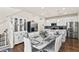 Kitchen and dining area with white cabinets and marble table at 6251 N Malaya St, Aurora, CO 80019