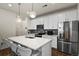 Modern kitchen with white cabinets, stainless steel appliances, and island at 6251 N Malaya St, Aurora, CO 80019
