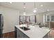Kitchen island with a large sink and seating for three at 6251 N Malaya St, Aurora, CO 80019