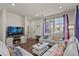 Bright living room featuring comfortable seating and a modern fireplace at 6251 N Malaya St, Aurora, CO 80019