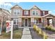 Two-story home with stone and siding exterior, front porch, and landscaping at 6251 N Malaya St, Aurora, CO 80019
