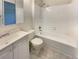 Clean bathroom with a bathtub, toilet, and updated vanity at 19237 E Kansas Dr, Aurora, CO 80017