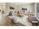 Virtually staged living room with light gray furniture and hardwood floors at 19237 E Kansas Dr, Aurora, CO 80017