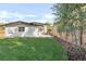 Landscaped backyard with grassy area and wood fence at 4930 E Ellsworth Ave, Denver, CO 80246