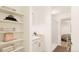 Clean bathroom with white vanity, shower, and built-in shelving at 22271 E 38Th Pl, Aurora, CO 80019