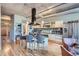 Modern kitchen with a large island, stainless steel appliances, and exposed ductwork at 1499 Blake St # 5I, Denver, CO 80202