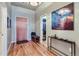 Bright entryway with hardwood floors, coat closet, and bench at 1499 Blake St # 5I, Denver, CO 80202