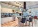 Modern kitchen with a large island, stainless steel appliances, and exposed ductwork at 1499 Blake St # 5I, Denver, CO 80202