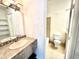Clean bathroom with a single sink vanity and a bathtub at 16001 E Alaska Pl # 7, Aurora, CO 80017