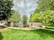 Community pool with stone wall and grassy area at 16001 E Alaska Pl # 7, Aurora, CO 80017