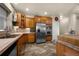 Modern kitchen with wood cabinets, stainless steel appliances, and tile floors at 533 Talus Rd, Monument, CO 80132