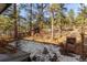 Backyard with shed, brick barbecue and snow-covered ground at 5274 S Hatch Dr, Evergreen, CO 80439