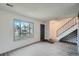 Living room featuring a large window and gray door at 404 S Carr St, Lakewood, CO 80226