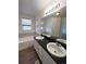 Bathroom with a large bathtub and double vanity at 2217 S Telluride Ct, Aurora, CO 80013