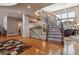 Grand entryway with curved staircase and hardwood floors at 10834 Bobcat Ter, Lone Tree, CO 80124