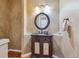 Elegant powder room with ornate vanity and a large oval mirror at 10834 Bobcat Ter, Lone Tree, CO 80124