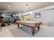 Finished basement with pool table, gym equipment, and ample space for entertainment at 10834 Bobcat Ter, Lone Tree, CO 80124