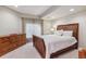 Basement bedroom with dresser and large bed at 10834 Bobcat Ter, Lone Tree, CO 80124