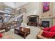 Two story living room with a fireplace, hardwood floors and a spiral staircase at 10834 Bobcat Ter, Lone Tree, CO 80124