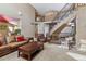 Open living room with a spiral staircase, high ceilings, and comfortable seating at 10834 Bobcat Ter, Lone Tree, CO 80124