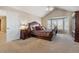 Spacious main bedroom with wood furniture and a ceiling fan at 10834 Bobcat Ter, Lone Tree, CO 80124