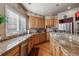 Spacious kitchen with granite countertops and ample wood cabinets at 10834 Bobcat Ter, Lone Tree, CO 80124
