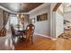 Formal dining room with hardwood floors, a large table, and access to the kitchen at 10834 Bobcat Ter, Lone Tree, CO 80124