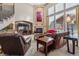 Spacious living room with a fireplace, large windows, and comfortable seating at 10834 Bobcat Ter, Lone Tree, CO 80124