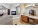 Elegant bathroom with double vanity and a soaking tub at 10834 Bobcat Ter, Lone Tree, CO 80124