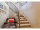 Elegant curved staircase with seating area at 10834 Bobcat Ter, Lone Tree, CO 80124