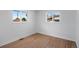 Simple bedroom with hardwood floors and two large windows at 1845 W 46Th Ave, Denver, CO 80211