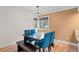 Dining area with a modern chandelier and blue chairs at 4885 Silver Spruce Ln, Evergreen, CO 80439