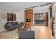 Living room with a brick fireplace and sliding glass doors leading to a deck at 4885 Silver Spruce Ln, Evergreen, CO 80439