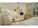 Bedroom with a dresser, chair, and window, showing a bright and airy room at 300 Hudson St # 202, Denver, CO 80220