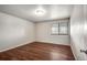 Simple bedroom with hardwood floors and window at 8335 Fairmount Dr # 9-206, Denver, CO 80247