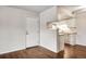 Bright kitchen and entryway with light wood flooring and white appliances at 8335 Fairmount Dr # 9-206, Denver, CO 80247