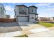 Two-story house with gray siding and two-car garage at 13502 E 100Th Ave, Commerce City, CO 80022