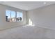 Well-lit bedroom with carpet and large windows offering neighborhood views at 13502 E 100Th Ave, Commerce City, CO 80022