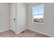 Bright entryway with wood-look floors, neutral walls, and a view from a large window at 13502 E 100Th Ave, Commerce City, CO 80022