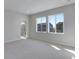 Bright bedroom featuring carpet and large windows with neighborhood views at 13502 E 100Th Ave, Commerce City, CO 80022