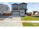 Two-story house with gray siding and two-car garage at 13502 E 100Th Ave, Commerce City, CO 80022