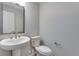 Clean and simple bathroom with pedestal sink and toilet at 13502 E 100Th Ave, Commerce City, CO 80022