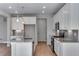 Modern kitchen featuring white cabinets, stainless steel appliances, and a large island at 13502 E 100Th Ave, Commerce City, CO 80022