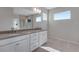 Modern bathroom with double vanity, a large mirror and shower at 13502 E 100Th Ave, Commerce City, CO 80022