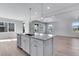 Modern kitchen with white cabinets, stainless steel appliances and a large island at 13502 E 100Th Ave, Commerce City, CO 80022